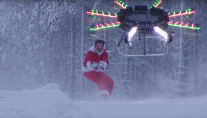 無人機拉動 Casey Neistat  在雪山上滑行。